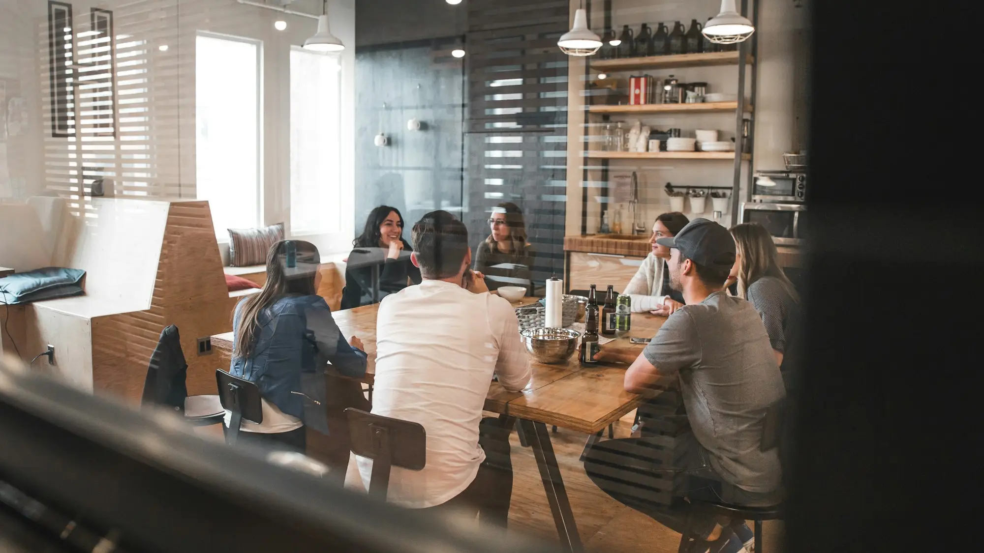 Small business team meeting around a table in an Auckland city office with harbour views